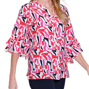 Woman wearing a colorful patterned blouse on a white background