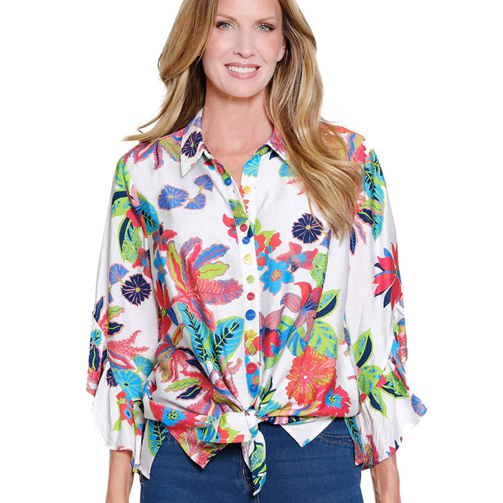 Woman wearing a colorful floral blouse on a white background