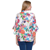 Woman wearing a colorful floral blouse on a white background