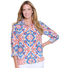 Woman wearing a colorful patterned blouse on a white background