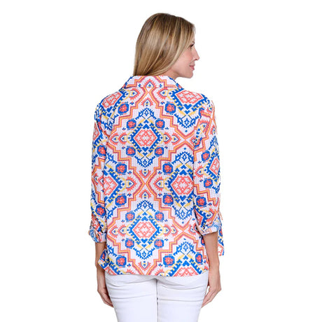 Woman wearing a colorful patterned blouse on a white background