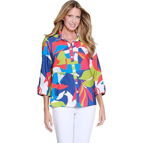 Woman wearing a colorful patterned blouse on a white background