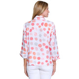 Woman wearing a polka dot blouse with a white background