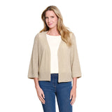 A woman modeling a textured, open-front cardigan in a light beige color, worn over a cream top and blue jeans, against a plain white background.