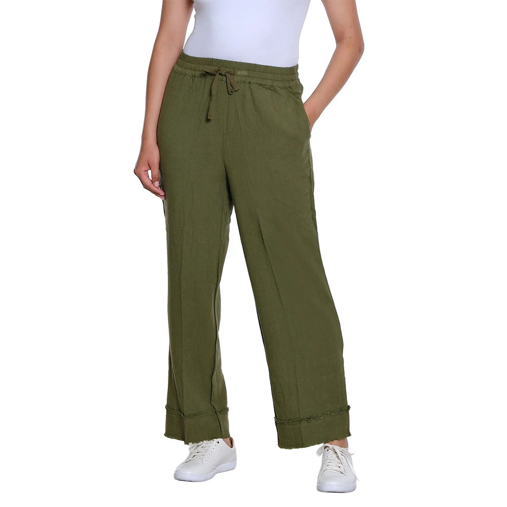 A person wearing olive green wide-leg drawstring pants with a white top and white sneakers, shown against a plain white studio background.