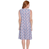 Woman wearing a sleeveless dress with a colorful polka dot pattern on a white background