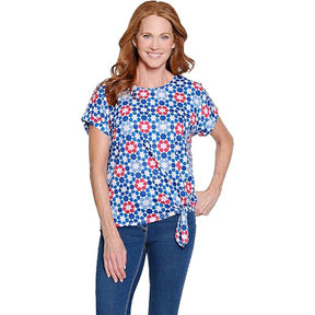 Woman wearing a floral patterned top on a white background