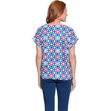 Woman wearing a colorful floral blouse on a white background