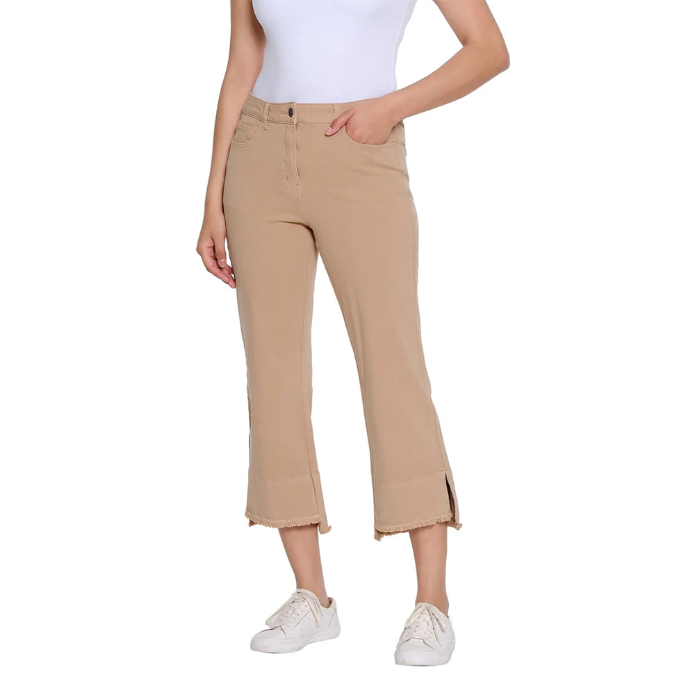 Person wearing beige pants and white sneakers on a white background
