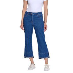 Person wearing blue jeans and a white top on a white background