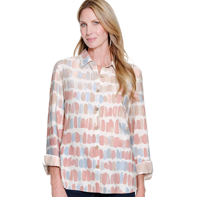 Woman wearing a patterned blouse on a white background