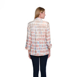 Woman wearing a patterned blouse on a white background