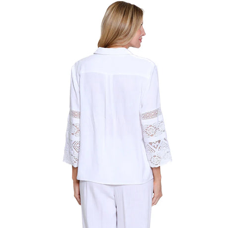 Woman wearing a white blouse with lace sleeves on a white background