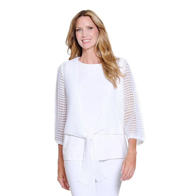 Woman wearing a white outfit with a textured top on a white background