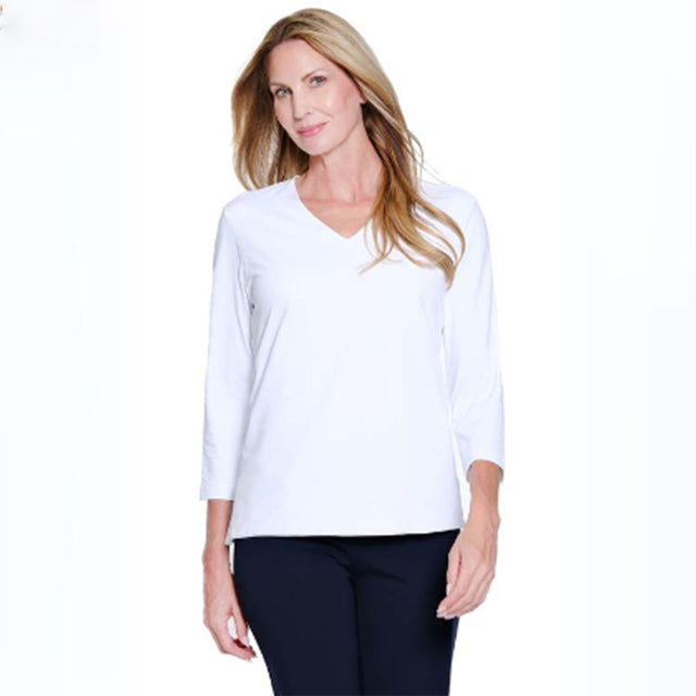 Woman wearing a white long-sleeve top on a white background
