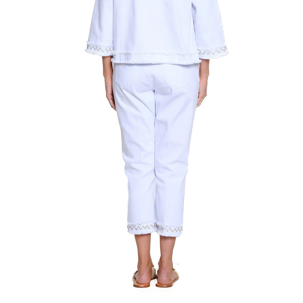 Person wearing a white outfit with lace details on a white background