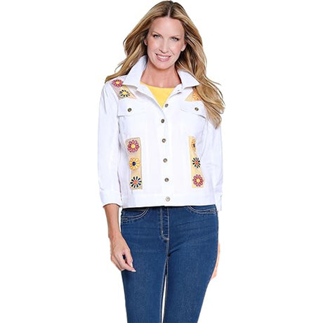 Woman wearing a white denim jacket with floral embroidery on a white background