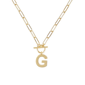 Gold necklace with a letter 'G' pendant on a white background