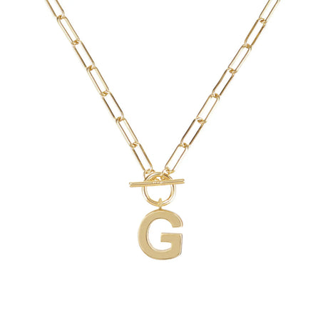 Gold necklace with a letter 'G' pendant on a white background