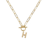 Gold necklace with a 'H' pendant on a white background
