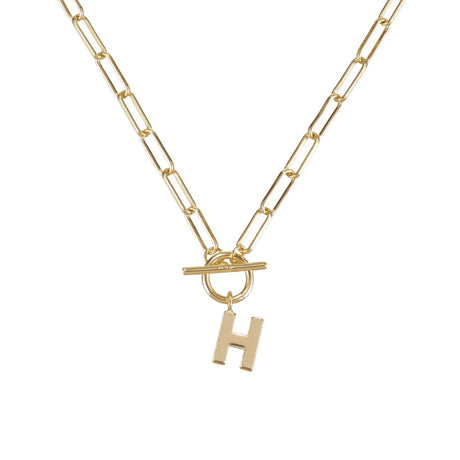Gold necklace with a 'H' pendant on a white background