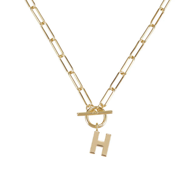 Gold necklace with a 'H' pendant on a white background