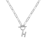 Silver necklace with a toggle clasp and 'H' charm on a white background