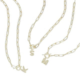Three gold chain necklaces with charms on a light gray background