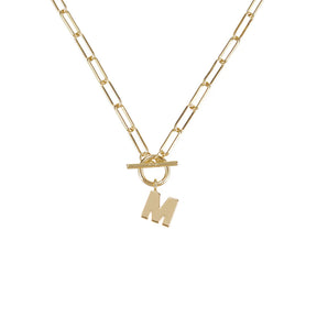 Gold necklace with a letter 'M' pendant on a white background