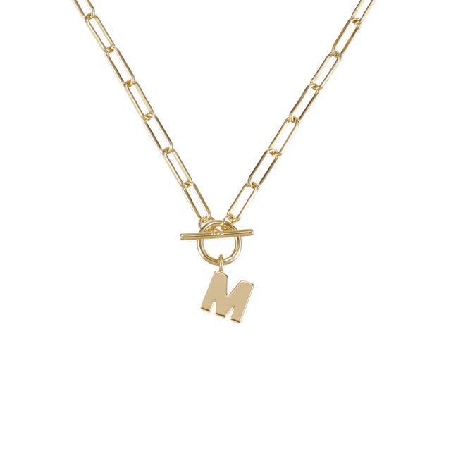Gold necklace with a letter 'M' pendant on a white background