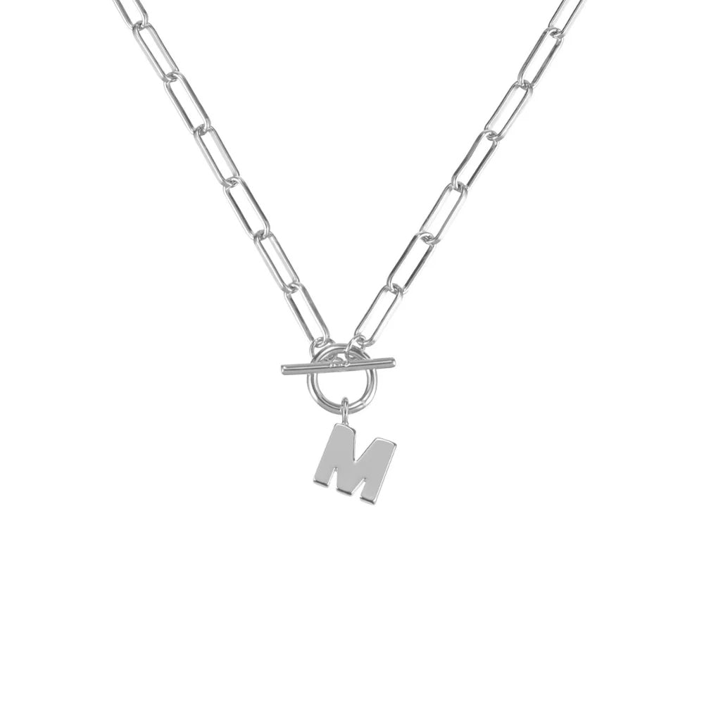 Silver necklace with a toggle clasp and 'M' pendant on a white background