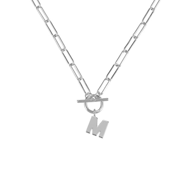 Silver necklace with a toggle clasp and 'M' pendant on a white background