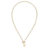 Gold necklace with a letter 'N' pendant on a white background