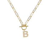 Gold necklace with a toggle clasp and 'B' pendant on a white background