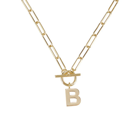 Gold necklace with a toggle clasp and 'B' pendant on a white background