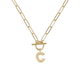 Gold necklace with a letter 'C' pendant on a white background