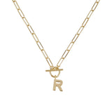 Gold necklace with a letter 'R' pendant on a white background