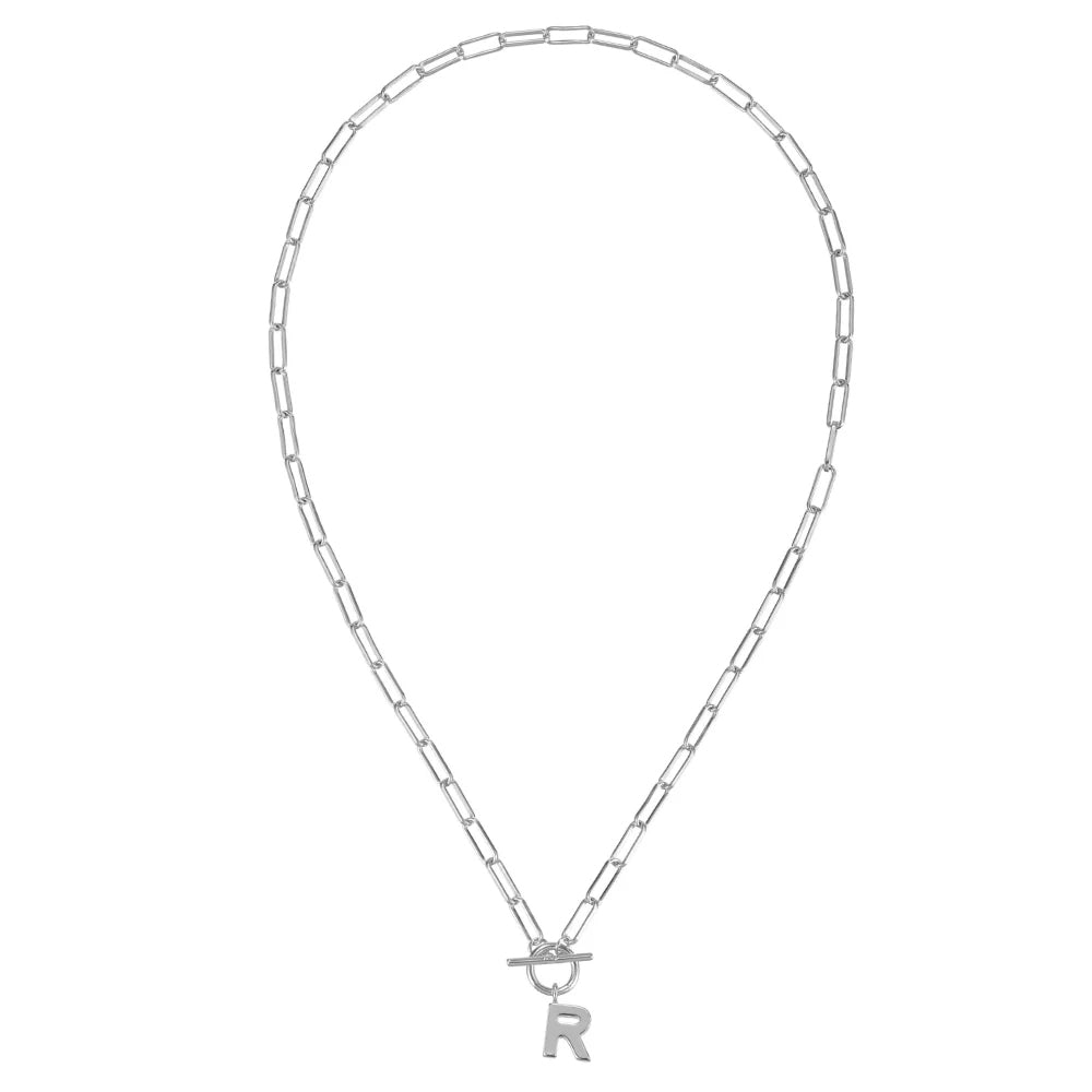Silver necklace with 'R' pendant on a white background