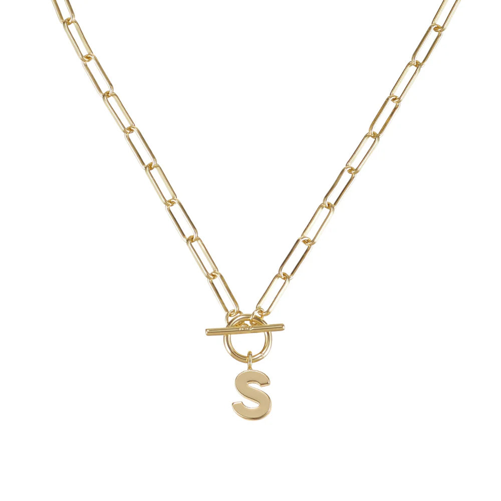 Gold necklace with a letter 'S' pendant on a white background
