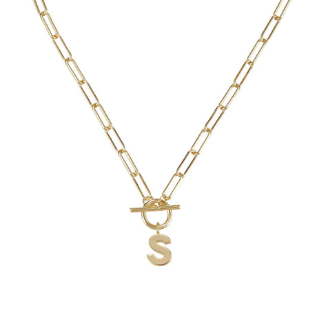 Gold necklace with a letter 'S' pendant on a white background