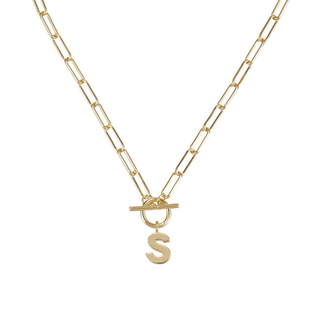 Gold necklace with a letter 'S' pendant on a white background