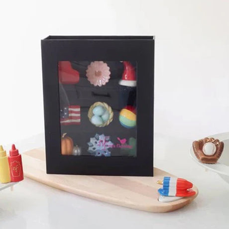 Black gift box with colorful bath bombs on a white background