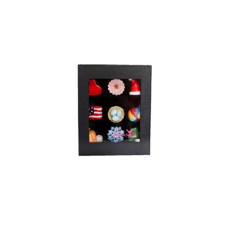 Decorative chocolate assortment in a black box on a white background