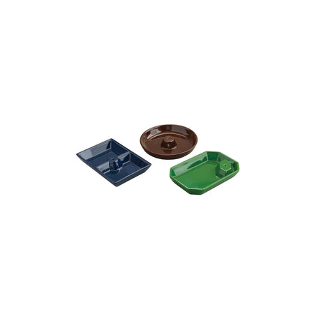 Three small ceramic dishes in blue, brown, and green on a white background