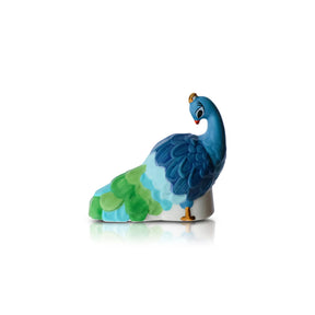 Colorful ceramic peacock figurine on a white background