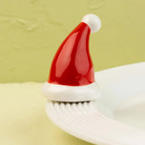 White platter with a red Santa hat on a light green background