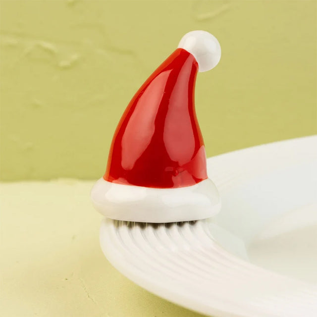 White platter with a red Santa hat on a light green background