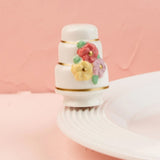Decorative bottle cap with colorful flowers on a pink background