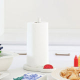 White paper towel holder with a red watermelon-shaped item on a kitchen counter.