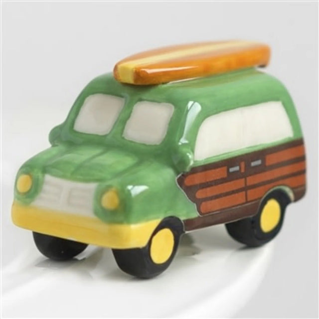 Toy car with a surfboard on top on a white background